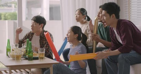 Wall Mural - Group of asia people young adult friend man and woman scream shout excited sit at home sofa couch watch FIFA world cup game live on TV feeling upset disappointed sad anger in loss racing result.