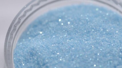 Poster - blue sequins in a jar rotate in a circle