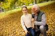 © BGStock72 - Grandfather spending time with his granddaughter in park on autumn day
