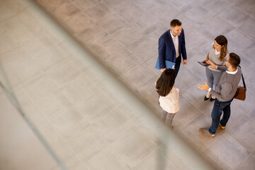 Aerial view at business people team discussing in the office hallway