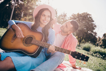 Wall Mural - Photo of dreamy charming two people together wear casual outfits playing guitar sitting blanket outside garden