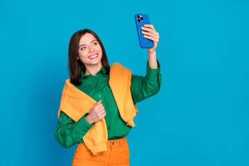 Canvas Print - Photo of charming positive lady hold telephone make selfie record video isolated on blue color background