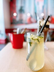 Canvas Print - Lemonade drink with a spoon and straw on the table