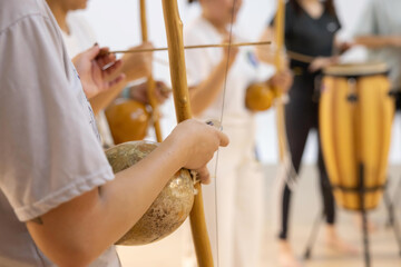 Wall Mural - Capoeirsta Playing Berimbau in a Capoeira Roda