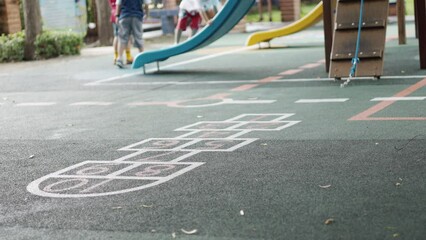 blurred background with copy space of playground floor and seeing kindergarten kids who are playing 