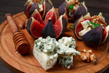 Appetizer, Figs with blue cheese, walnut, honey, on a wooden board, top view, close-up, no people,