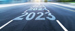© xy - Black asphalt road with new year numbers 2023, 2024 to 2026 with white dividing lines
