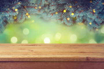 Canvas Print - Empty wooden table over beautiful green pine tree branches background.  Christmas holiday mock up for design and product display.