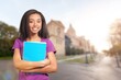 © BillionPhotos.com - Happy female student outdoor standing near her college