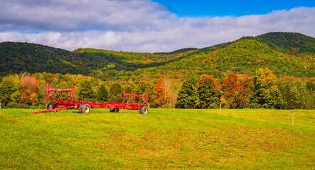 Wall Mural - autumn landscape of Vermont farmland with large red wagon for hauling 
