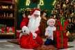 © ZaStock - Cute boy building high tower from gift boxes with Santa Claus. Christmas Scenes. New Year concept