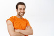 © Cookie Studio - Handsome healthy guy smiles, shows shoulder with band aid after covid 19 vaccination shot, vaccine injection, stands over white background