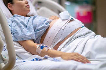 Wall Mural - A woman in labor, giving birth in the hospital. Childbirth and pregnancy.