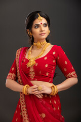 Poster - Pretty Indian young Hindu Bride against grey background.