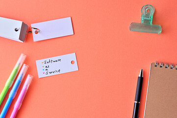 Poster - There is word card with the word Software as a Service on the desk.