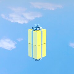 Wall Mural - Yellow gift box with blue ribbon put on mirror glass reflection sky. 3D render. Minimal Christmas concept idea.