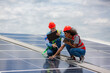 © chokniti - technician engineer working on checking maintenance service with solar batteries near solar panels at sunny day in solar power plant station on rooftop, electricity energy of photovoltaic industrial