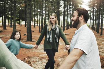 Family circle, forest and nature game with children, parents or community for wellness and natural adventure. Healthy people holding hands with kid together in woods for outdoor, countryside holiday