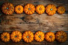 Pumpkins On A Wooden Rustic Background. Yellow Autumn Harvest Pumpkins On The Festive Table. Fall Holidays, Halloween, Thanksgiving Day, Food Concept.