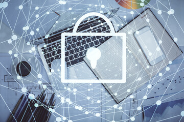 Poster - Double exposure of lock hologram drawing over study table background with computer. Concept of data security. Top view.