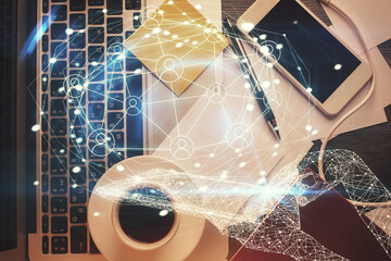 Poster - Social network hologram drawings over computer on the desktop background. Top view. Multi exposure. Concept of people connection.