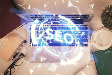 Poster - Double exposure of SEO drawing over study table background with computer. Concept of search. Top view.