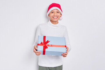 Happy Asian man in christmas hat holding present gift box isolated on white background. Man getting the gift from santa claus