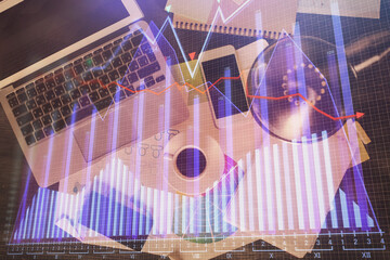 Poster - Financial market graph and top view computer on the desktop background. Multi exposure. Investment concept.