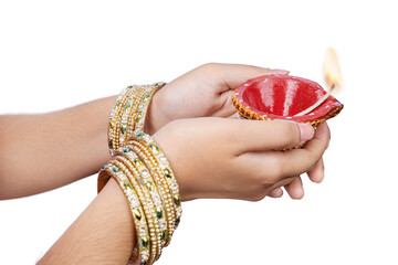 Wall Mural - Woman hand holding Diya oil lamps for the Diwali festival