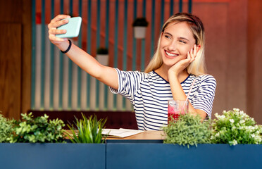 Wall Mural - Portrait of young excited woman making a video chat on digital device. People education work concept