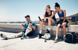© Allistair F/peopleimages.com - Sport friends, phone and relax in city after exercise and morning cardio, physical exercise and soccer training. Fitness, soccer player and town hangout with diverse people talking after workout