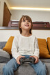 © Svitlana - Caucasian little boy play video game with joystick