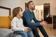 © Svitlana - European little boy and father playing video game