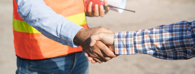 Wall Mural - construction company handshaking with material supplier.