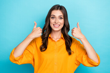 Photo of nice cheerful lady beaming smile arms fingers show thumbs up isolated on blue color background