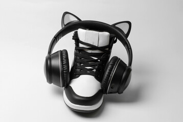 Sneakers with wireless headphones on a white background