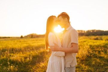 Wall Mural - portrait of happy smiling young couple in love hugging and kissing with closed eyes enjoying each ot