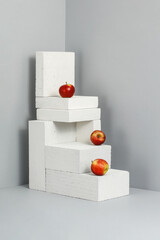 Poster - Stone pedestal with fruits. Gray background and shadow. 