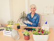 © Jelena Stanojkovic - Hooby biologist pensioner woman arranges the plant in her living room.