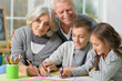 © aletia2011 - Portrait of grandparents and grandchildren drawing at home