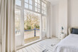 © ADDICTIVE STOCK - Bedroom interior next to a bright open window