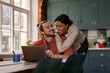 © ReeldealHD images - Happy young adult couple at home looking at personal finances using a laptop