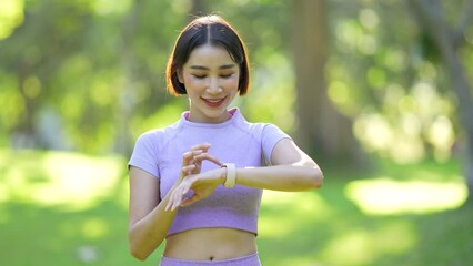 Wall Mural - Attractive Asian woman in sportswear practicing yoga in the outdoor park