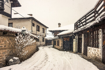 Bansko old town street in snowy winter day.Cityscape in retro vintage color.