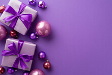 Christmas Day Concept. Top View Photo Of Lilac Gift Boxes With Ribbon Bows Pink And Purple Baubles On Isolated Violet Background With Copyspace