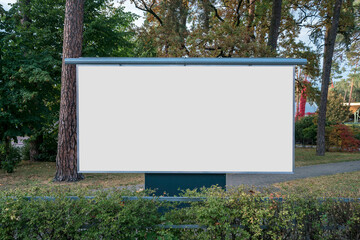 Wall Mural - Large blank banner with white copy space for mockup standing at urban park in autumn season outdoor