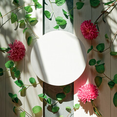 Wall Mural - Round canvas, aster flowers and green branches with leaves are on a white wooden table. Abstract flower composition for social media, advertising layout. Top view. Flat lay. Copy space.