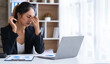 © crizzystudio - tired business woman sleepy and bored from sitting at a desk for a long time and has office syndrome