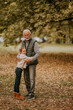 © BGStock72 - Grandfather spending time with his granddaughter in park on autumn day