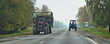 Tractors on village asphalted road in work . Farming transport